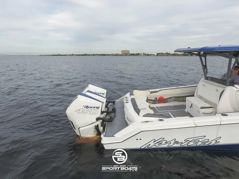 Slide: The Image of 2021 Nor-Tech 390 Sport boat on open water with powerful outboard engines. - 19