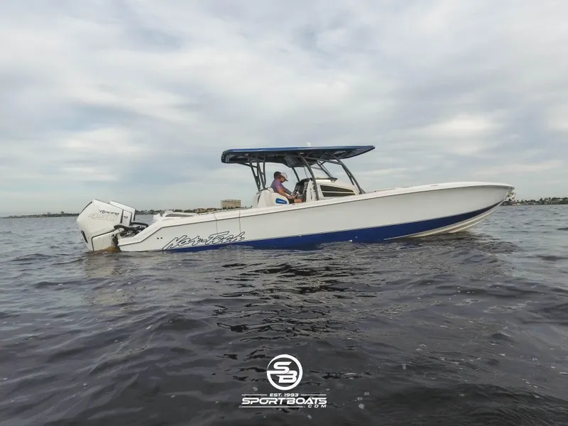 Slide: The Image of 2021 Nor-Tech 390 Sport boat on calm water with a cloudy sky. - 2