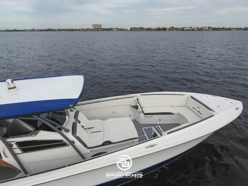 Slide: The Image of 2021 Nor-Tech 390 Sport boat on calm waters, featuring sleek white seating and a blue canopy. - 22