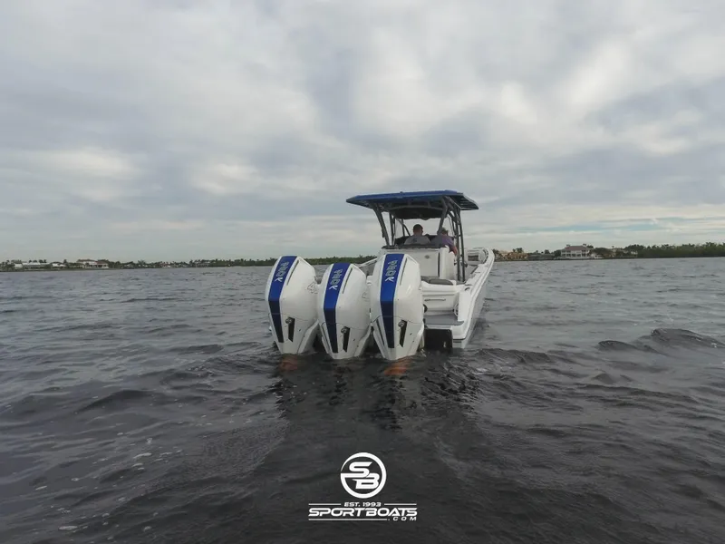 Slide: The Image of 2021 Nor-Tech 390 Sport boat with triple outboard engines on open water. - 27
