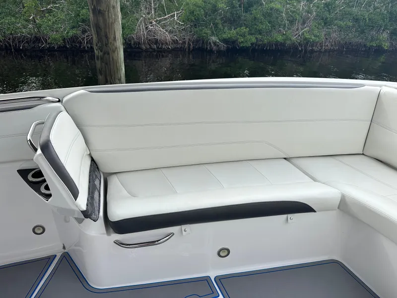 Slide: The Image of 2021 Nor-Tech 390 Sport boat interior seating with white and black upholstery. - 35