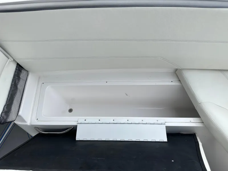 Slide: The Image of 2021 Nor-Tech 390 Sport boat storage compartment with white interior. - 37