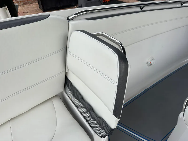Slide: The Image of 2021 Nor-Tech 390 Sport boat interior seating with white and gray upholstery. - 39
