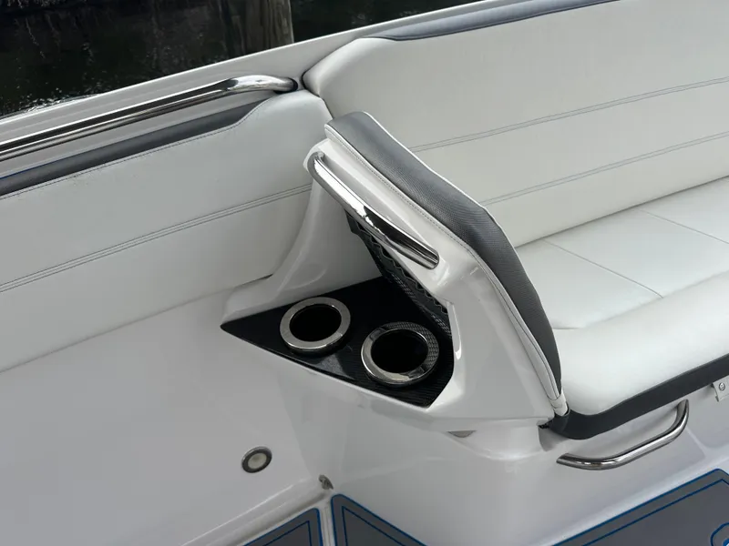 Slide: The Image of 2021 Nor-Tech 390 Sport boat interior with white seating and dual cup holders. - 40