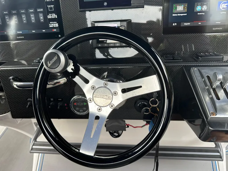Slide: The Image of Steering wheel and dashboard of a 2021 Nor-Tech 390 Sport boat. - 45