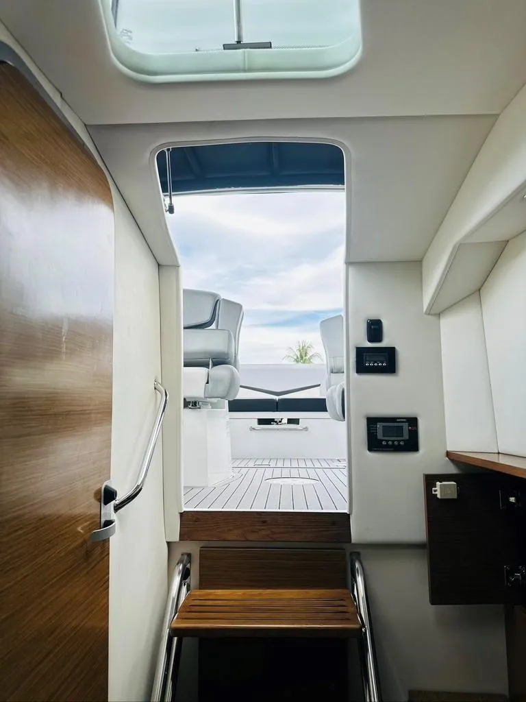 Slide: The Image of Interior view of 2015 Cruisers Sport Series 328 yacht, showing stairs to deck. - 10