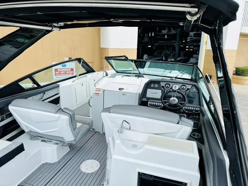 Slide: The Image of 2015 Cruisers Sport Series 328 boat interior with helm and seating. - 4