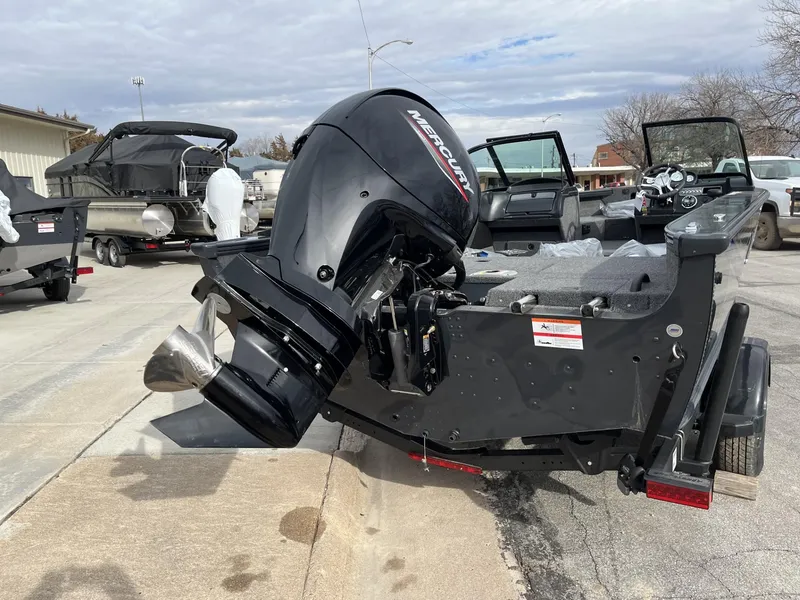 Slide: The Image of 2025 Lund 1875 Crossover XS boat with Mercury outboard motor in a parking lot. - 6