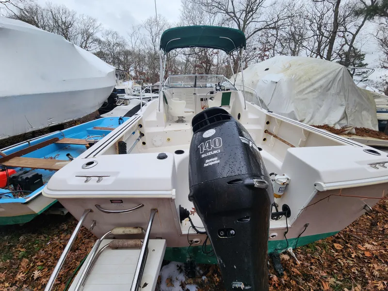 Slide: The Image of 1997 Pro-Line 201 Walkaround boat with Suzuki 140 outboard motor, parked outdoors. - 10