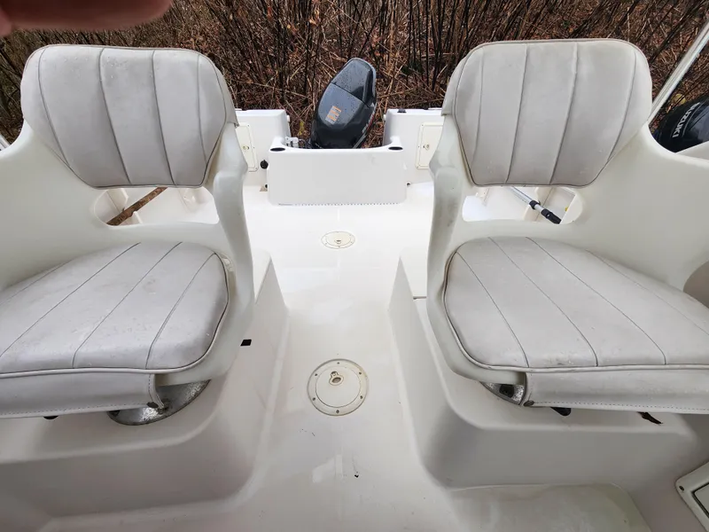 Slide: The Image of 1997 Pro-Line 201 Walkaround boat interior with two white cushioned seats. - 15