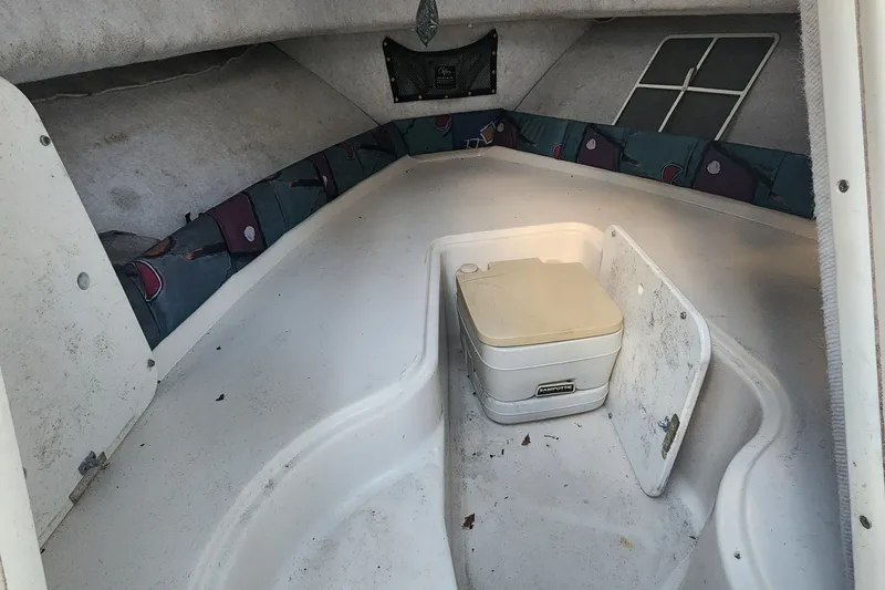 Slide: The Image of 1997 Pro-Line 201 Walkaround cabin interior with storage and seating area. - 8