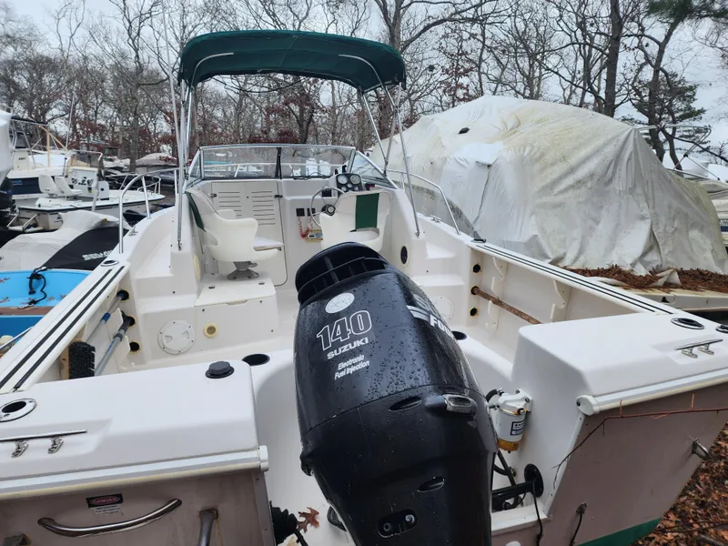 Slide: The Image of 1997 Pro-Line 201 Walkaround boat with Suzuki 140 engine, parked outdoors. - 9