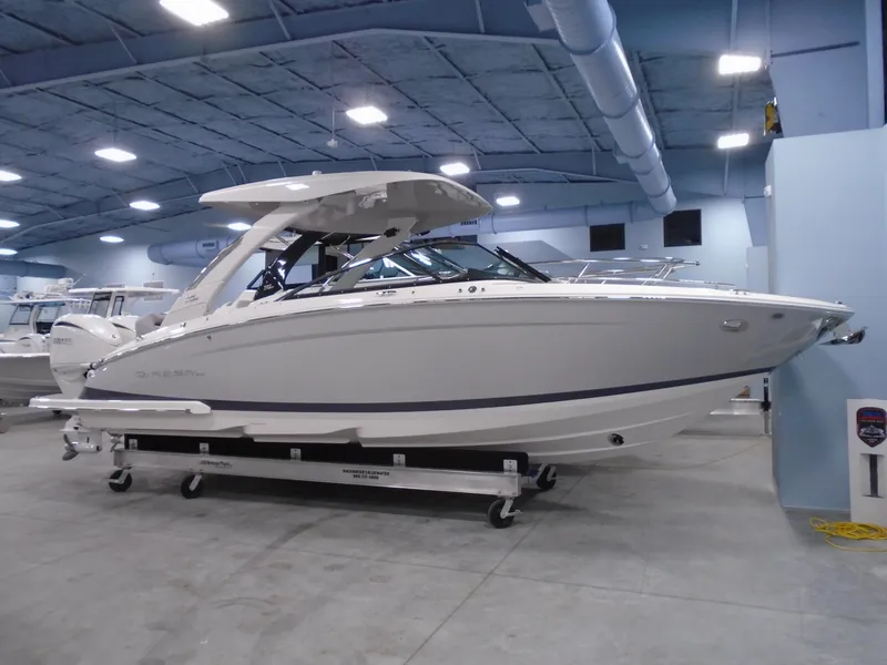 Slide: The Image of 2024 Regal LX9 boat displayed indoors on a trailer. - 1