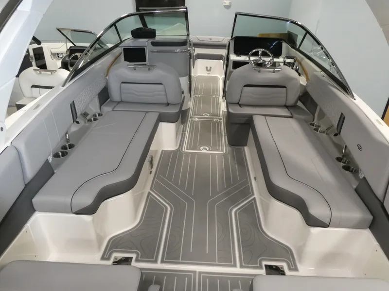 Slide: The Image of 2024 Regal LX9 boat interior with gray seating and modern dashboard. - 12