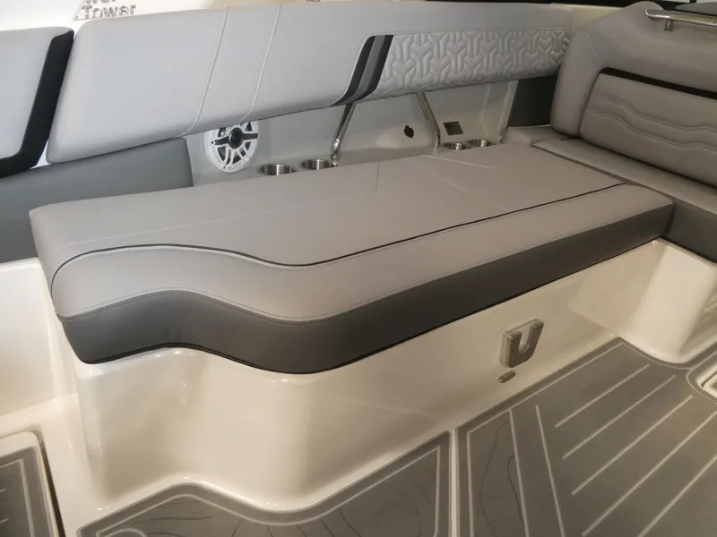 Slide: The Image of 2024 Regal LX9 boat interior seating with gray upholstery and integrated speaker. - 14