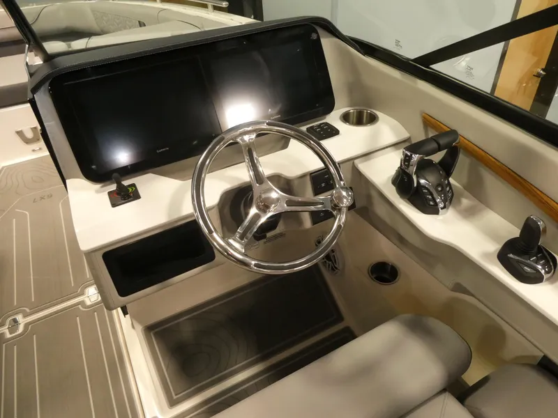 Slide: The Image of 2024 Regal LX9 boat cockpit with modern steering wheel and dual displays. - 15