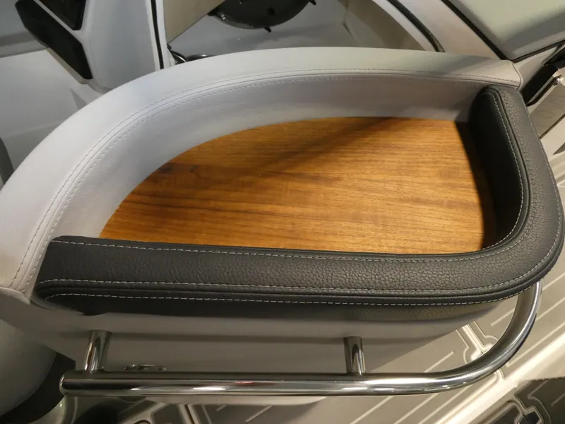 Slide: The Image of 2024 Regal LX9 boat seat with wooden inlay and black leather trim. - 17