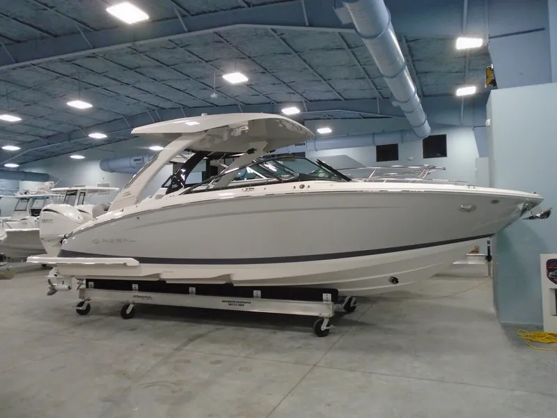 Slide: The Image of 2024 Regal LX9 boat displayed indoors, showcasing sleek design and modern features. - 2