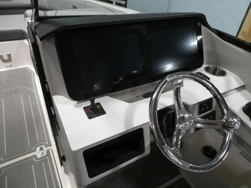 Slide: The Image of 2024 Regal LX9 boat dashboard with dual screens and chrome steering wheel. - 22