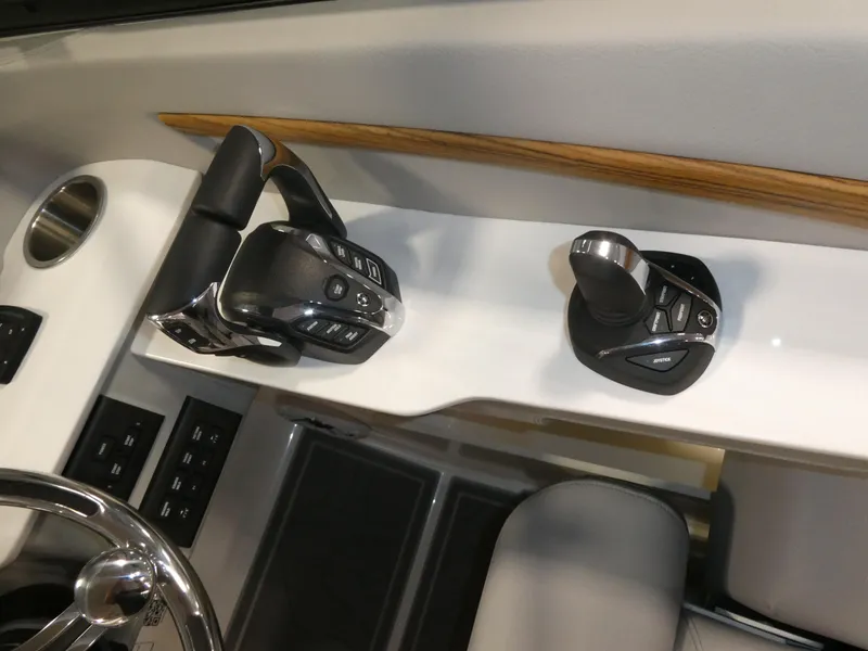 Slide: The Image of 2024 Regal LX9 boat control panel with throttle and joystick. - 23