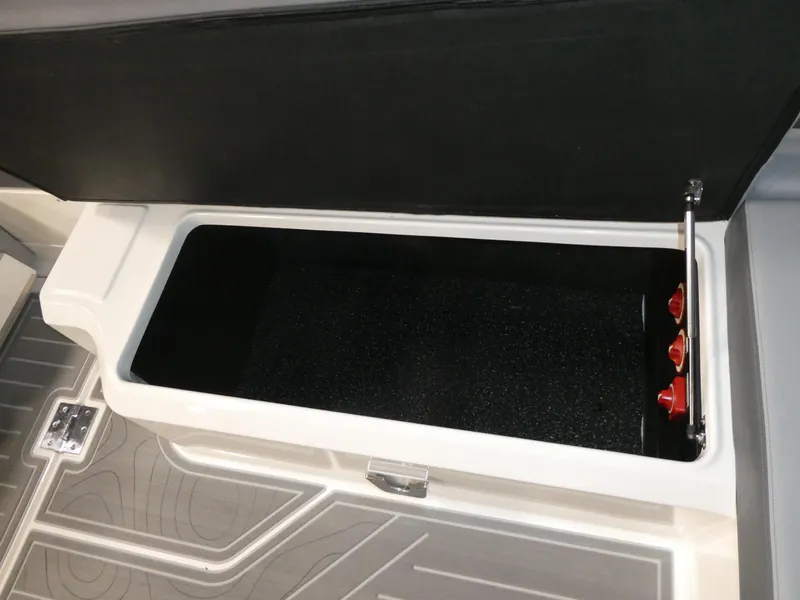 Slide: The Image of 2024 Regal LX9 storage compartment with open lid and interior view. - 32