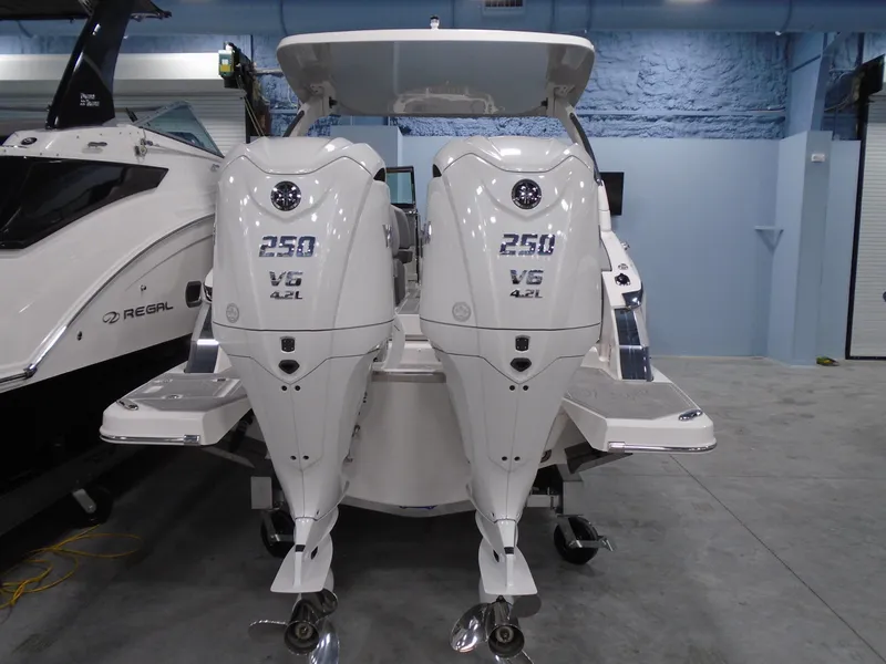 Slide: The Image of 2024 Regal LX9 boat with twin 250 V6 outboard engines in a showroom. - 41