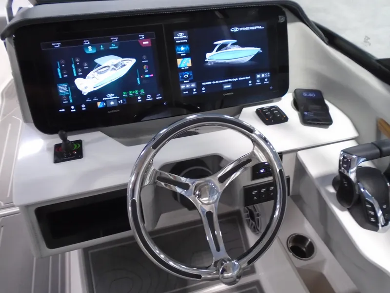 Slide: The Image of 2024 Regal LX9 boat dashboard with dual digital displays and modern steering wheel. - 9