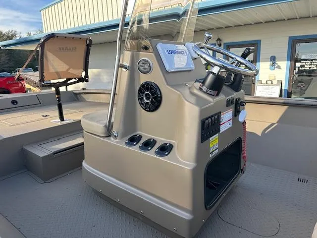 Slide: The Image of 2024 SeaArk 2072 VFX Elite CC boat console with steering wheel and controls. - 3