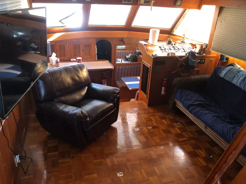 Slide: The Image of Interior of 1985 CHB Motor Yacht with leather chair, TV, and helm station. - 13