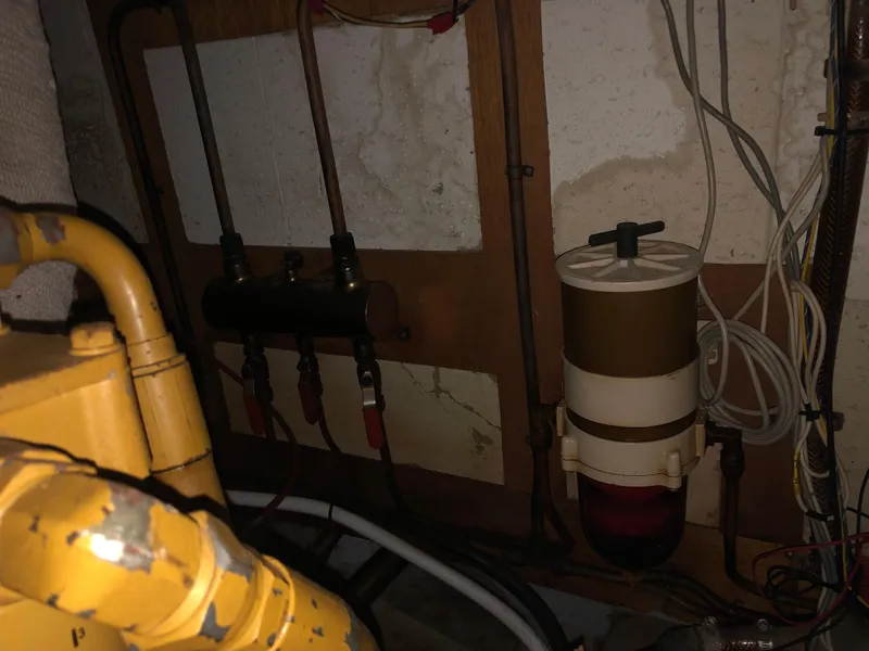Slide: The Image of Engine room of a 1985 CHB Motor Yacht showing fuel system components and wiring. - 24