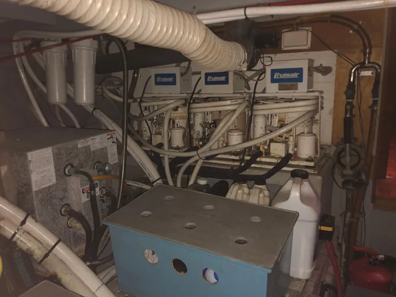 Slide: The Image of Engine room of a 1985 CHB Motor Yacht with Cruisair systems and various equipment. - 26