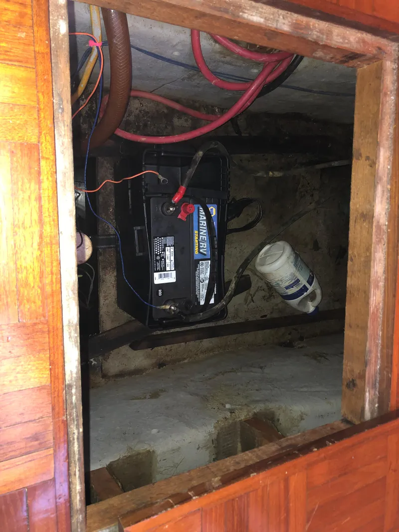 Slide: The Image of Battery compartment of a 1985 CHB Motor Yacht with wiring and maintenance items. - 28