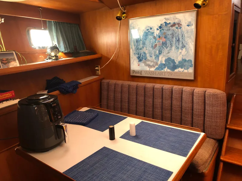 Slide: The Image of Interior of 1985 CHB Motor Yacht with dining area, air fryer, and nautical decor. - 31