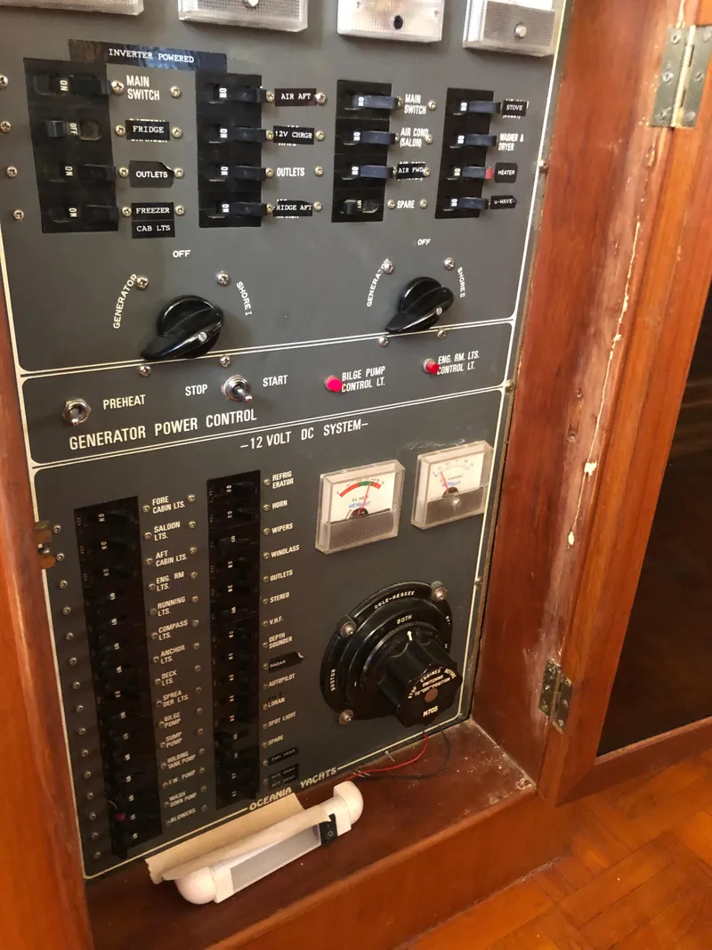 Slide: The Image of Control panel of a 1985 CHB Motor Yacht with various switches and gauges. - 32