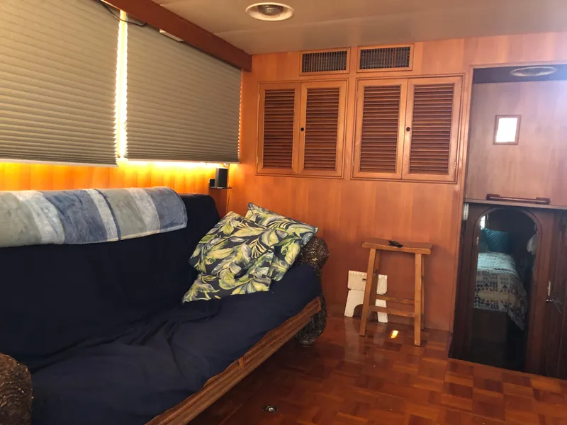 Slide: The Image of Interior of 1985 CHB Motor Yacht with wooden paneling, sofa, and cabin entrance. - 33
