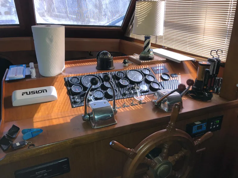 Slide: The Image of 1985 CHB Motor Yacht helm with controls, gauges, and navigation equipment. - 34