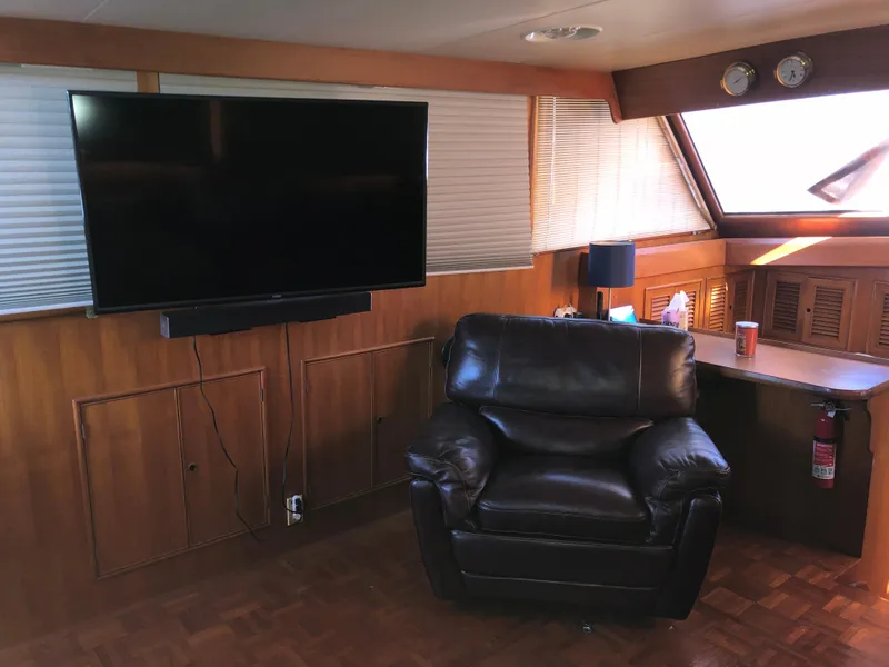 Slide: The Image of Interior of 1985 CHB Motor Yacht with leather chair, TV, and desk. - 36