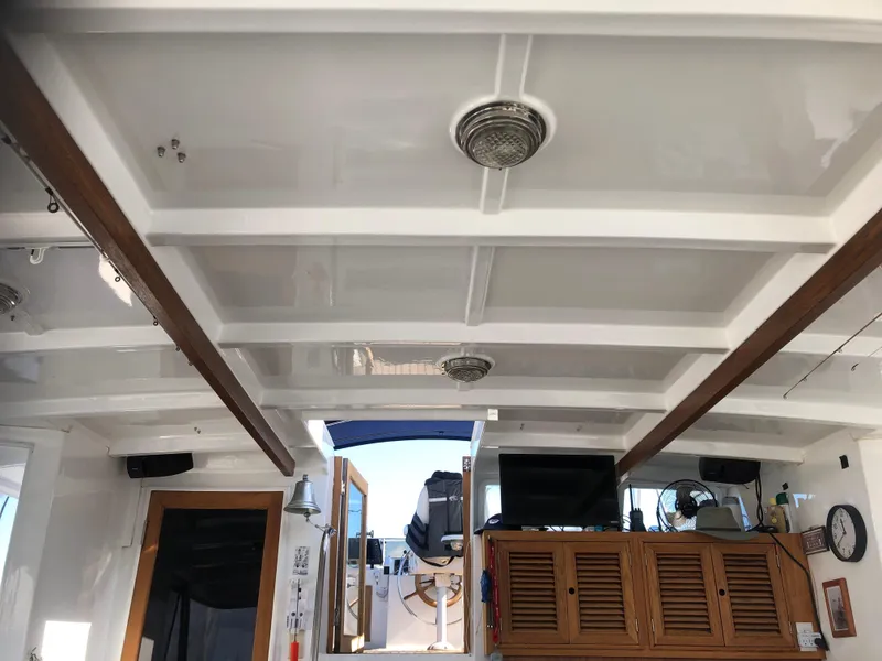 Slide: The Image of Interior of 1985 CHB Motor Yacht with wooden accents and ceiling lights. - 37