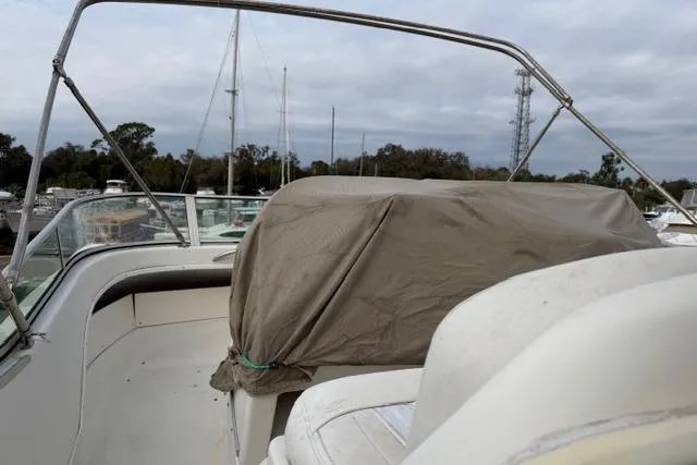 Slide: The Image of 2000 Maxum 4100 SCA boat deck with covered seating, docked in a marina. - 107