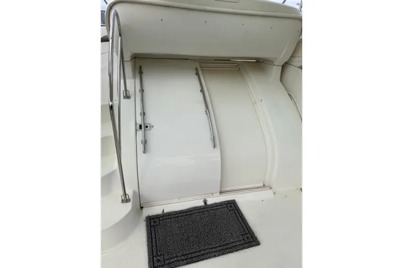Slide: The Image of 2000 Maxum 4100 SCA yacht entrance with metal railings and a black mat. - 108