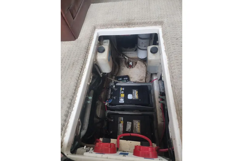Slide: The Image of Battery compartment of a 2000 Maxum 4100 SCA boat, showing dual batteries and wiring. - 109