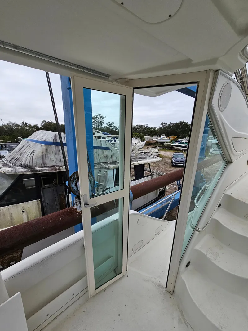 Slide: The Image of 2000 Maxum 4100 SCA yacht interior with sliding glass door and docked boats. - 48
