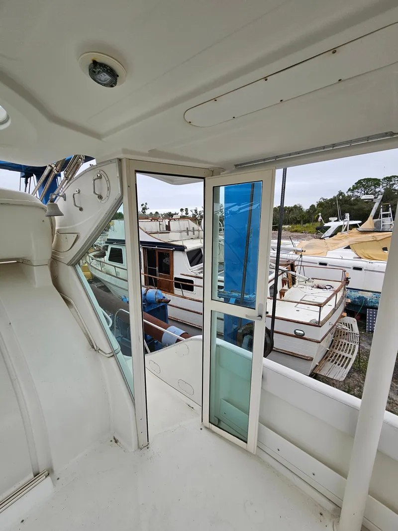 Slide: The Image of 2000 Maxum 4100 SCA yacht interior view with docked boats in background. - 49