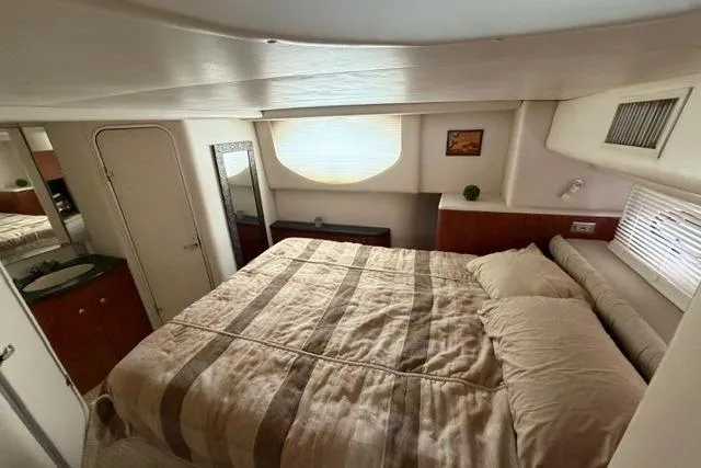 Slide: The Image of Luxurious bedroom interior of 2000 Maxum 4100 SCA yacht with cozy bedding. - 75