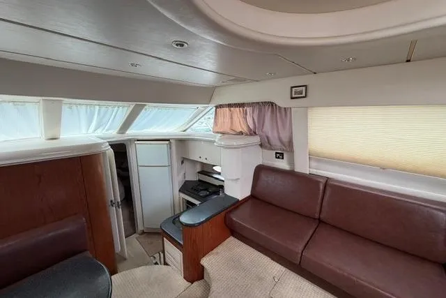 Slide: The Image of Interior of 2000 Maxum 4100 SCA yacht with brown leather seating and modern amenities. - 76
