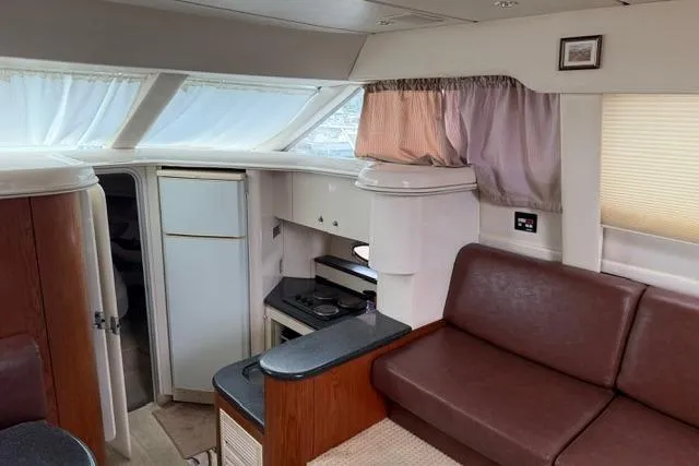 Slide: The Image of Interior of 2000 Maxum 4100 SCA yacht with kitchen and seating area. - 78