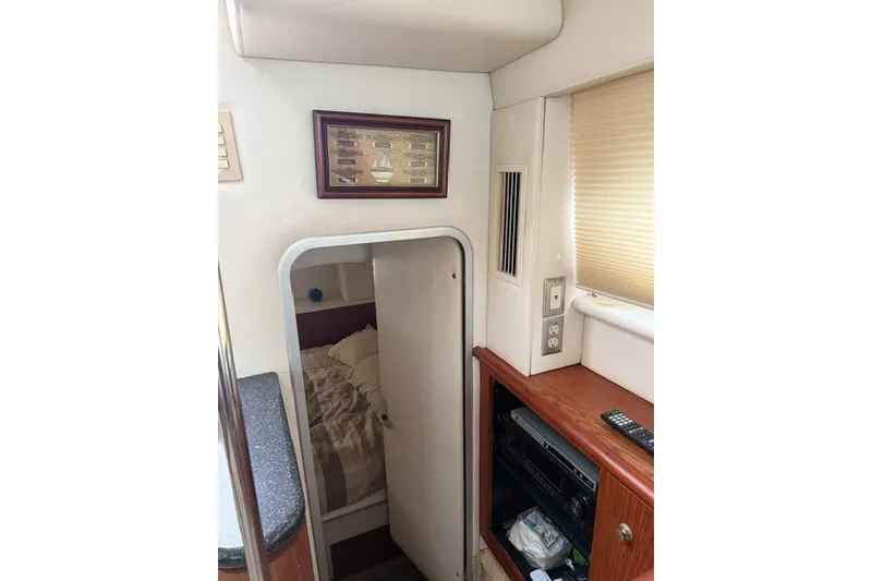 Slide: The Image of Interior of 2000 Maxum 4100 SCA yacht showing cabin entrance and wooden cabinetry. - 79