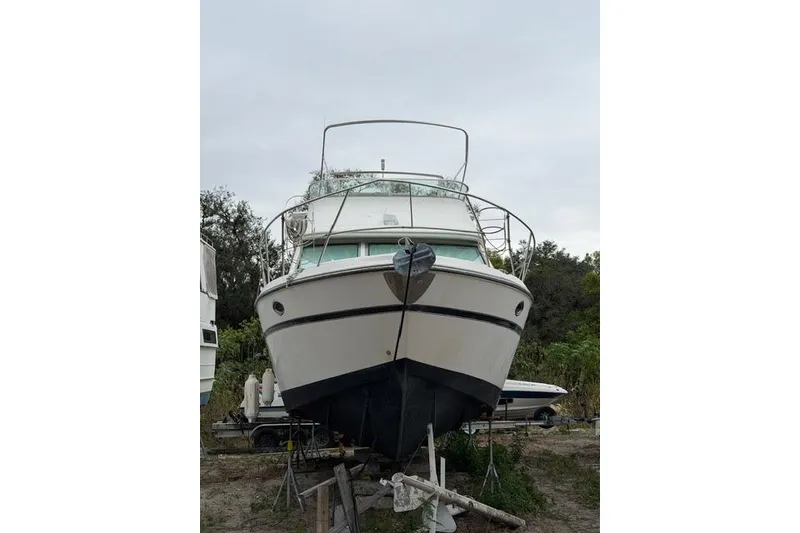 Slide: The Image of 2000 Maxum 4100 SCA yacht on land, front view, overcast sky. - 87