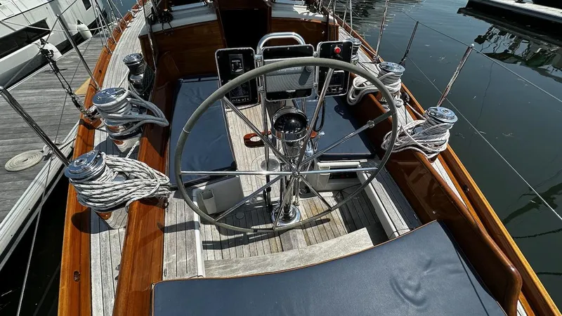 Slide: The Image of 2004 Lyman-Morse Sparkman & Stephens Sloop cockpit with steering wheel and winches. - 10