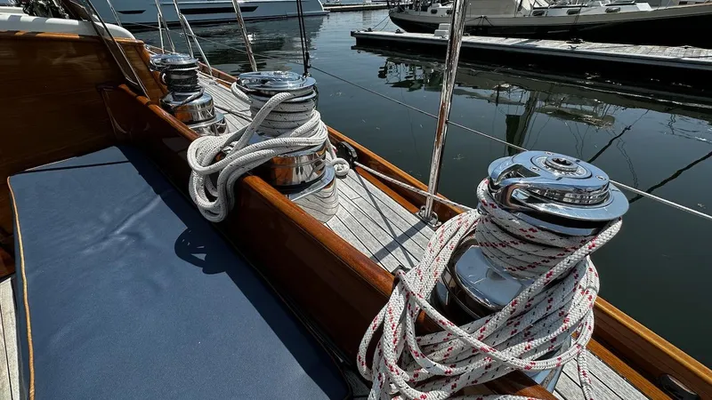 Slide: The Image of Deck of 2004 Lyman-Morse Sparkman & Stephens Sloop with winches and coiled ropes. - 13